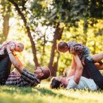 A joyful family enjoying playtime in a sunny park, capturing moments of laughter and happiness.